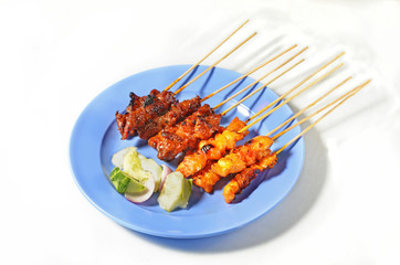 Beef and chicken satay  on a plate