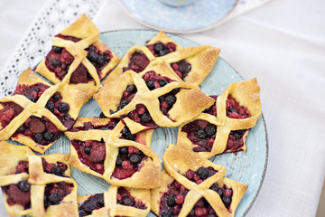 A festive table with cups of flowers and fruits. Delicious cake and cookies