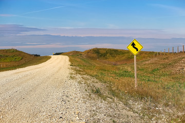 A curve ahead warning sign beside a country road