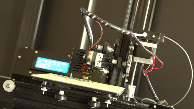 3D printer prints Prototype mechanical parts out of plastic filament