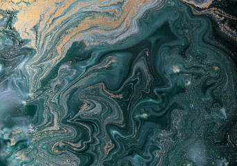 Marble abstract acrylic background. Blue and green marbling artwork texture. Golden glitter.
