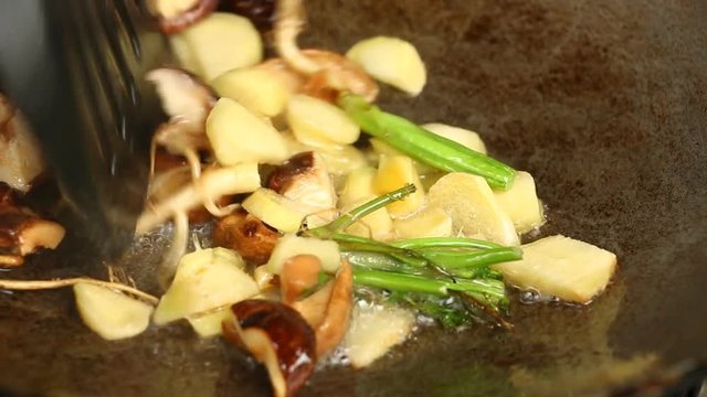 Frying  ginger shiitake and celery root  in pan
