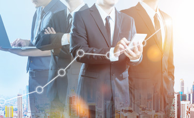 Business partner team standing together , double exposure effect with cityscape and stock statistics graph .