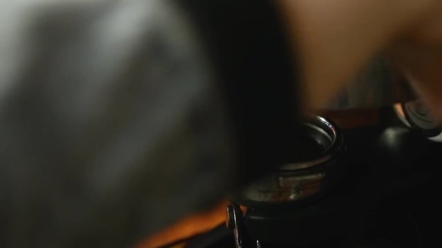 grinding coffee beans using the coffee machine