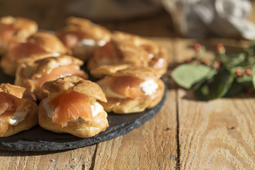 Salty profiteroles stuffed with riccota cheese and smoked salmon