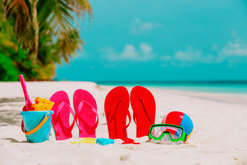 slippers, toys and diving mask at beach