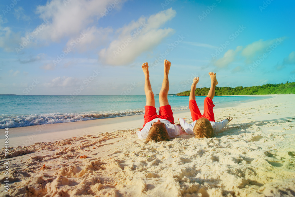 Wall mural father and son having fun on beach