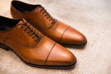 Brown leather classic male shoes on the floor