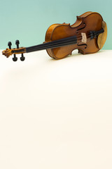 Fototapeta na wymiar Musical instrument violin on a colored background