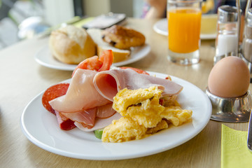 Bright and healthy breakfast, raw vegetables salad, fresh lettuce, cheese shakes, Western fried egg with the original bread,