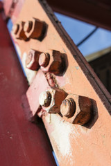 Cutting screws on the construction under red paint.