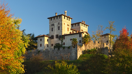 Autumn view of the medieval Cassacco castle in Friuli with the sunrise light, Italy
