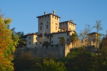 Fototapeta na wymiar Autumn view of the medieval Cassacco castle in Friuli with the sunrise light, Italy 