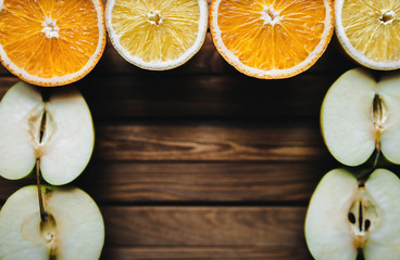 Frame of fresh fruits on wooden background. Copy space. Rustic.