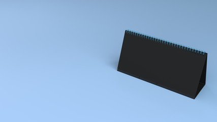 Black table calendar mock-up on blue surface