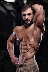 Fototapeta na wymiar sexy strong bodybuilder athletic men pumping up muscles with dumbbells