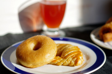 breakfast with donuts, salty croissant, fruit juice and milk