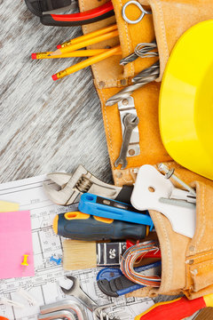 Different construction tools, wooden background