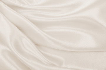 Obraz premium Smooth elegant golden silk or satin luxury cloth texture as wedding background. Luxurious Christmas background or New Year background design. In Sepia toned. Retro style