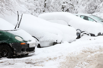 People walk on a very snowy sidewalk. People step on an snow-stray pathway. Icy sidewalk. Ice on sidewalks