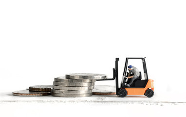 miniature worker driver on forklift truck loading stack coins