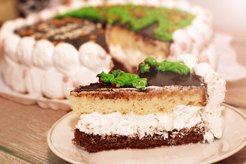 Pieces of homemade walnut carrot cake with icing cream on white plate.