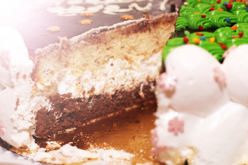 Pieces of homemade walnut carrot cake with icing cream on white plate.