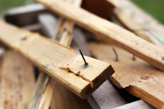 Rusty nail pierce the timber. Hazard of construction site from material. Occupational health and safety concept. Sources of tetanus germs.