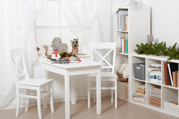 white room interior with christmas decoration, window, table and chair