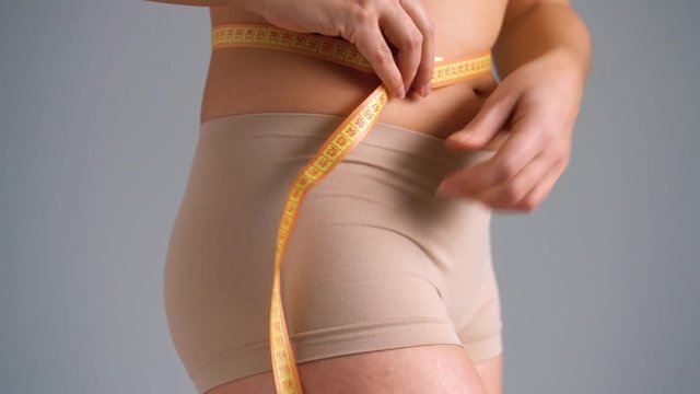 Healthy waist with measuring tape