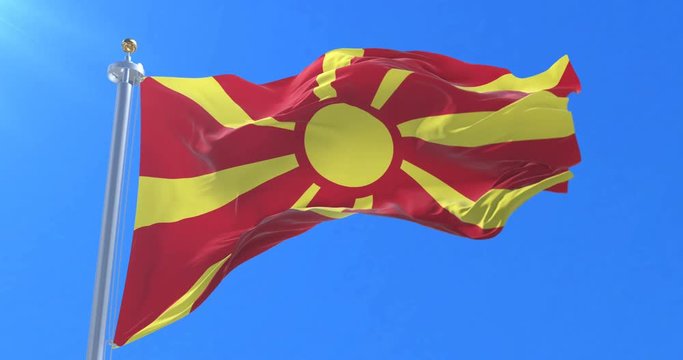 Flag of the Republic of Macedonia waving at wind in slow in blue sky, loop