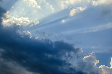 Naklejka na ściany i meble Dramatic cloudscape scene, colored sun lights on the blue sky, fluffy clouds