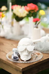 Beautiful flowers in a vase of stone and skull of stone