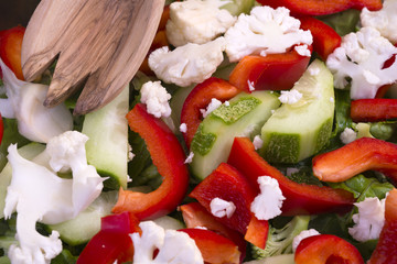 Dietary salad from nutritious vegetables - low-calorie and healthy daily food with wood spoon