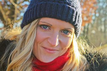 Smiling beautiful young woman with cap and blured background