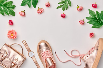 Fashion. Woman Gold Accessories Floral Set. Flat lay. Trendy fashion Handbag, Glamour gold Shoes. Pink Roses. Luxury Style. Spring Hipster Girl Outfit. Pastel Color