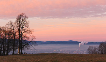 Fototapeta na wymiar Amazing winter sunrise over city Ceske Budejovice with trees, Czech landscape