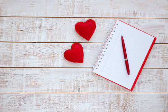 Valentines Day background with hearts over white wooden table