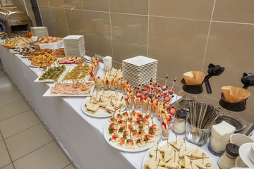 Catering food table of appetizers, snacks and canapes