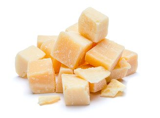 Small pieces of parmesan cheese on white background