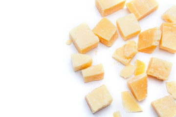 Small pieces of parmesan cheese on white background