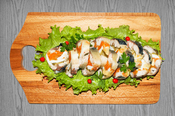 Roulade of sea fish mackerel with boiled vegetables and eggs, gala dinner, close-up