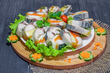 Roulade of sea fish mackerel with boiled vegetables and eggs, gala dinner, close-up