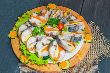 Roulade of sea fish mackerel with boiled vegetables and eggs, gala dinner, close-up
