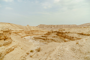 Fototapeta na wymiar Scenic landscape view from cliff on dry desert in Israel. 