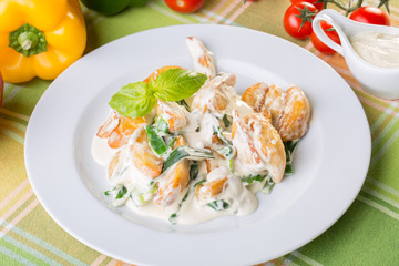 close up of potatoes with white sauce and onions