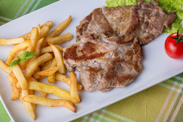 close up of pork steak with potatoes