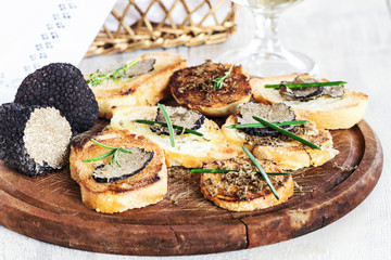 Italian black truffle bruschetta with herbs and oil on grilled or toasted crusty ciabatta bread