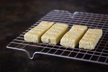 Freshly baked slices of shortbread cooling on a wire rack