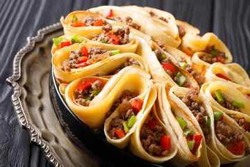 Pancakes stuffed with meat beef, peppers and onions closeup. horizontal
